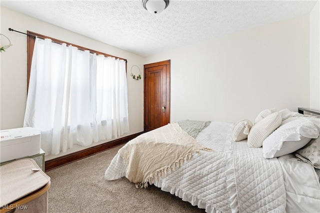 carpeted bedroom with a textured ceiling