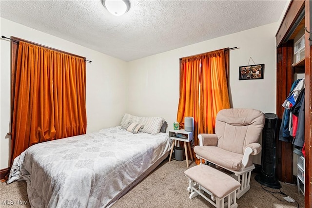 carpeted bedroom with a textured ceiling