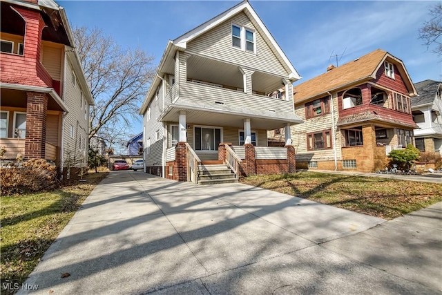 view of front of property with a porch and a balcony