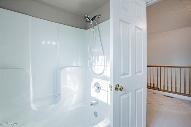 full bath featuring visible vents, bathing tub / shower combination, and a textured ceiling