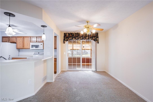 kitchen featuring light carpet, visible vents, white appliances, and ceiling fan