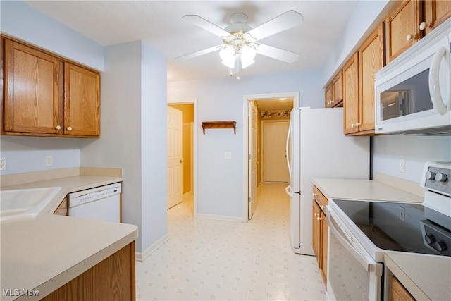 kitchen with white appliances, light floors, a sink, light countertops, and brown cabinets