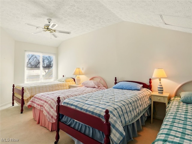 bedroom with lofted ceiling, attic access, ceiling fan, a textured ceiling, and light carpet