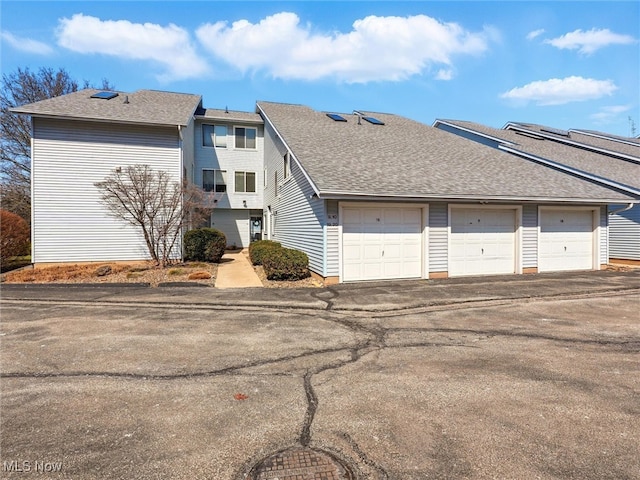 exterior space with roof with shingles