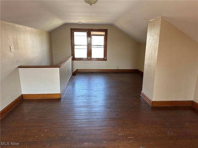 bonus room with baseboards, wood-type flooring, and lofted ceiling