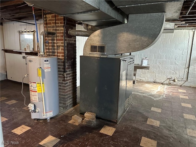 utility room featuring gas water heater and a sink