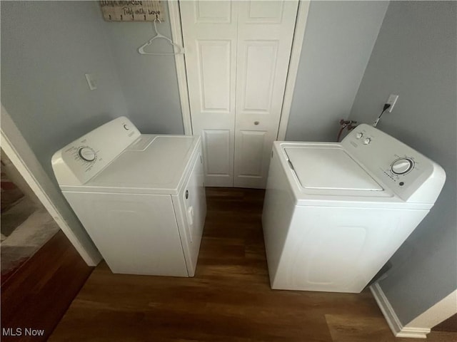 laundry area with dark wood-style floors, laundry area, and washer and clothes dryer