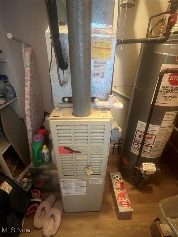 utility room with water heater and heating unit