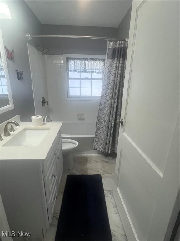 bathroom featuring vanity, plenty of natural light, marble finish floor, and shower / tub combo with curtain