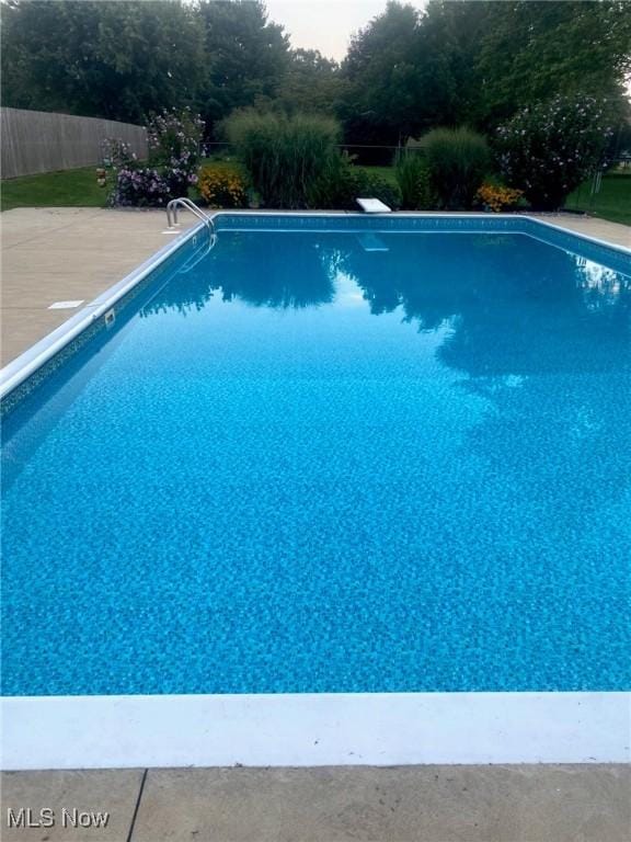 view of swimming pool with a fenced in pool and fence