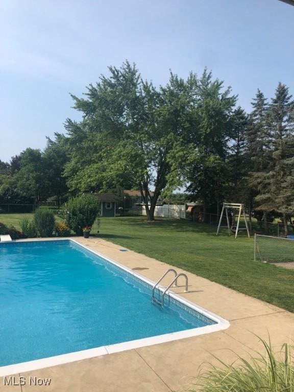 pool featuring a patio area and fence