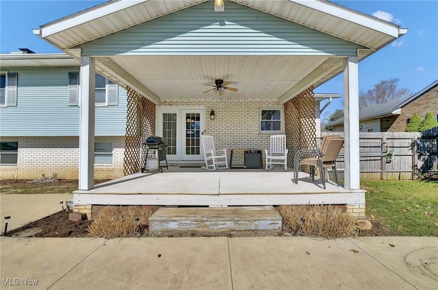 view of patio / terrace with a ceiling fan and fence