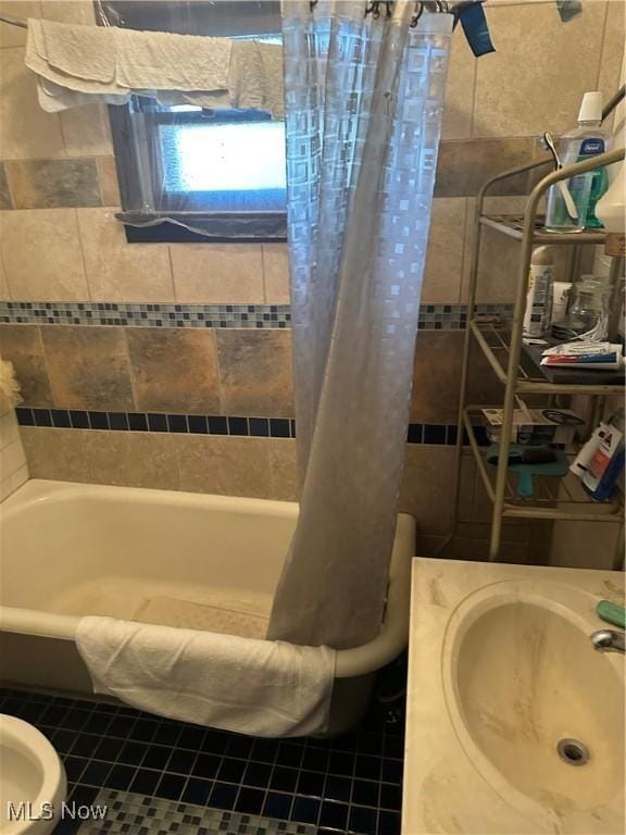 full bath featuring a sink and shower / tub combo with curtain