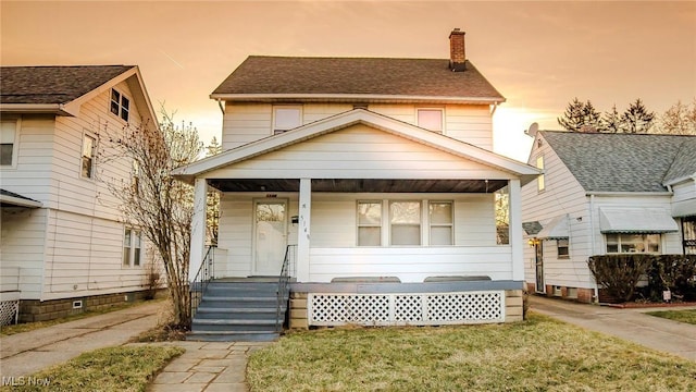 view of front of property with a porch and a chimney