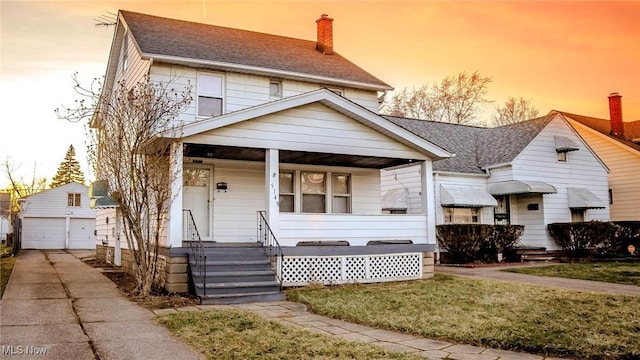 view of front of property with an outbuilding, a porch, a shingled roof, a chimney, and a garage