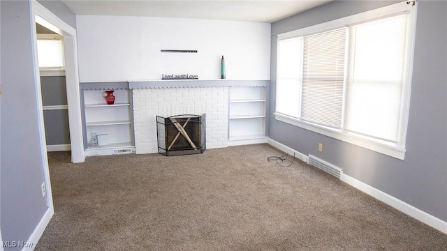 unfurnished living room featuring visible vents, baseboards, and carpet