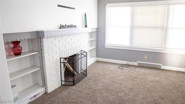 living room with visible vents, baseboards, a fireplace, and carpet flooring