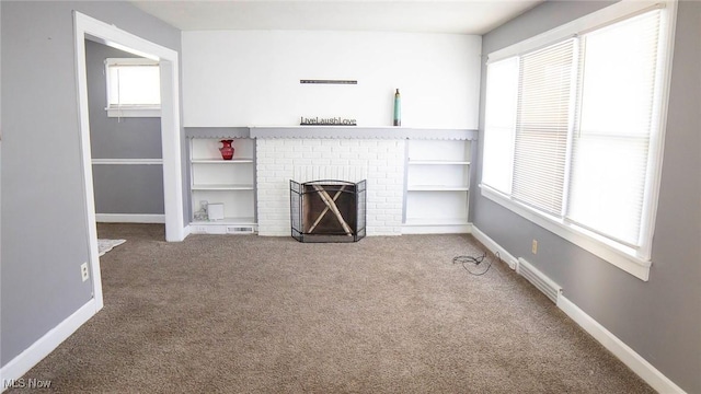 unfurnished living room featuring a brick fireplace, carpet flooring, visible vents, and baseboards