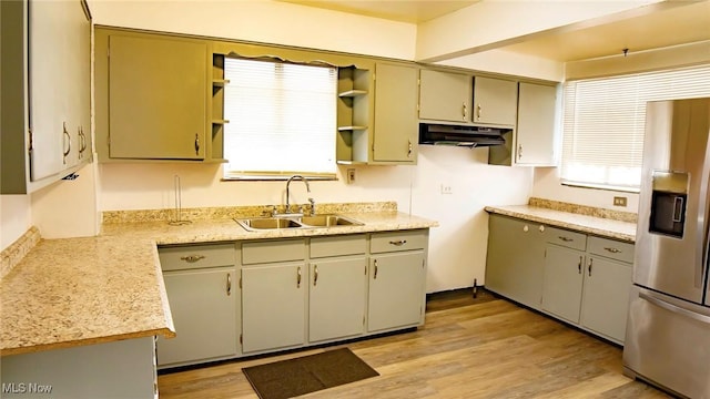 kitchen with open shelves, stainless steel fridge with ice dispenser, a sink, light wood-style floors, and under cabinet range hood