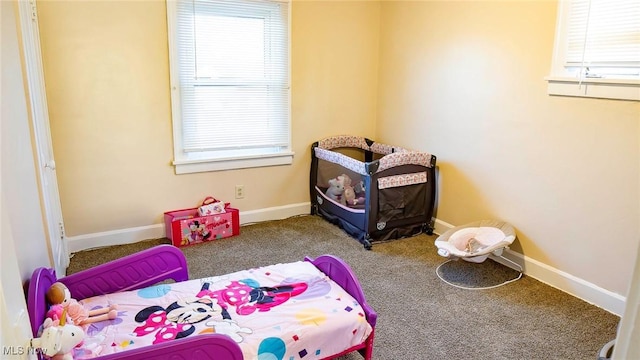 carpeted bedroom with baseboards