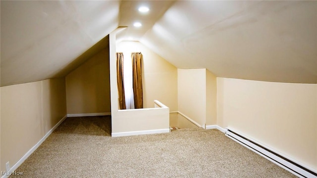 bonus room featuring carpet flooring, lofted ceiling, a baseboard heating unit, and baseboards