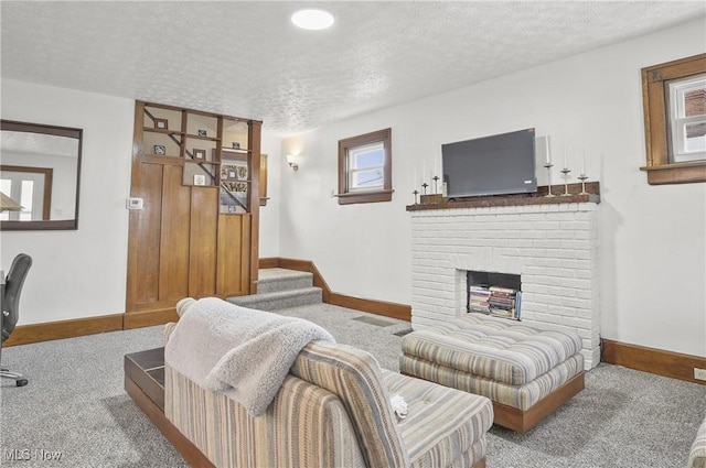 carpeted living area with stairway, a fireplace, baseboards, and a textured ceiling