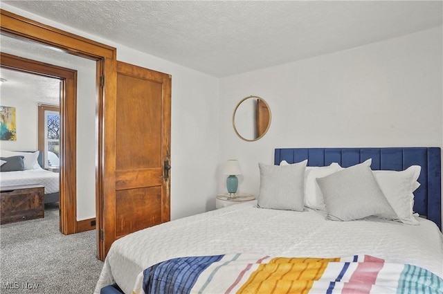 carpeted bedroom with a textured ceiling