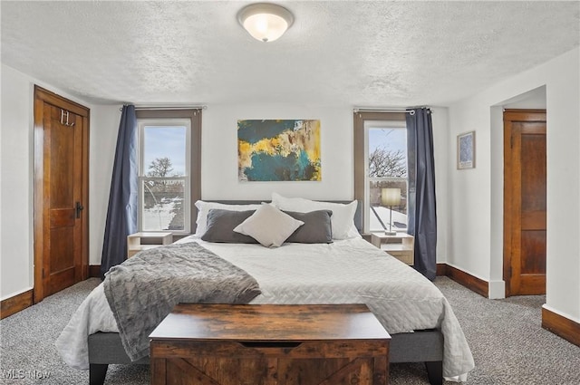 bedroom featuring baseboards, multiple windows, carpet, and a textured ceiling