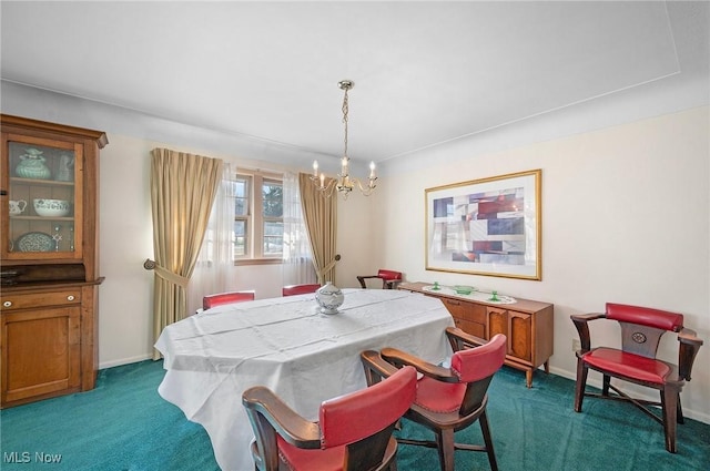 dining space featuring an inviting chandelier, baseboards, and dark carpet