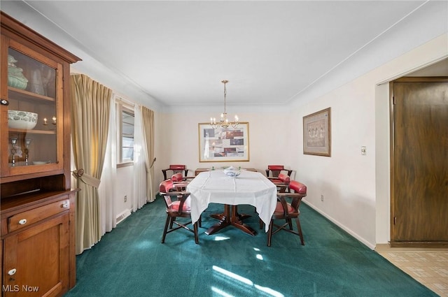 dining space with baseboards, dark carpet, and a chandelier