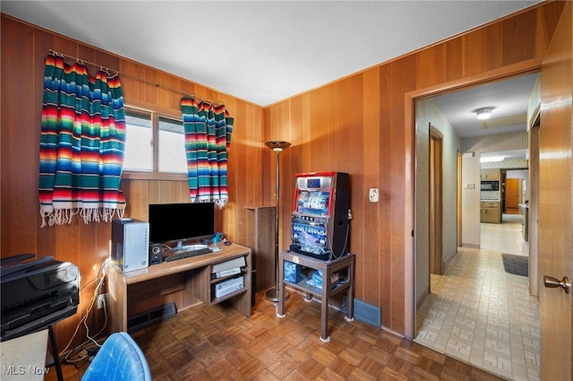 home office with wooden walls and visible vents