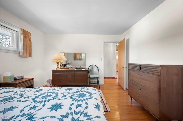 bedroom featuring light wood-style flooring and baseboards