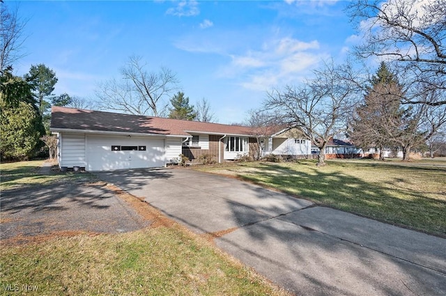 ranch-style house featuring a front lawn, a garage, and driveway