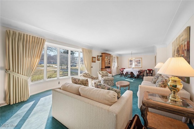 living area featuring baseboards, carpet floors, and a chandelier