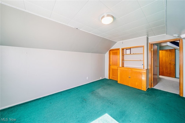 bonus room featuring dark colored carpet and vaulted ceiling