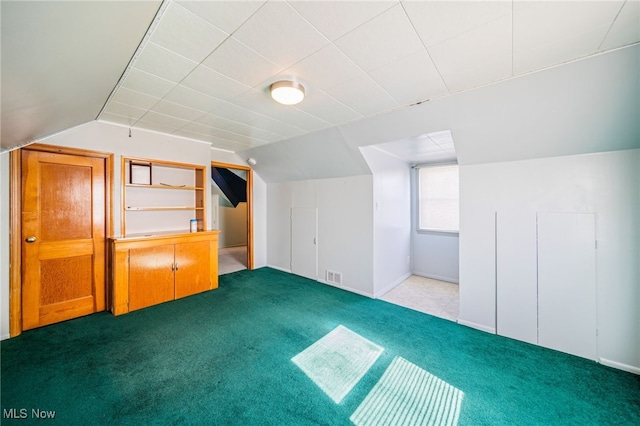 bonus room featuring vaulted ceiling, visible vents, and carpet floors