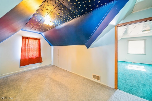 bonus room with visible vents, carpet floors, and vaulted ceiling