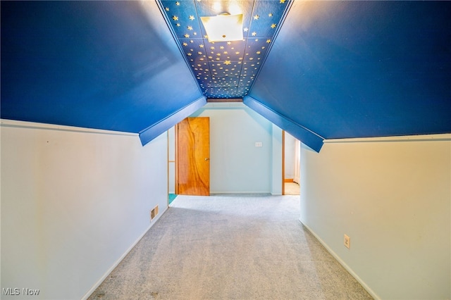 bonus room featuring baseboards, carpet, and vaulted ceiling