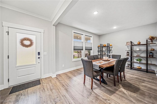 dining space featuring recessed lighting, wood finished floors, baseboards, and ornamental molding