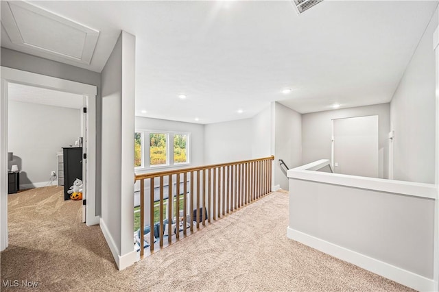 hallway with recessed lighting, carpet, visible vents, and baseboards