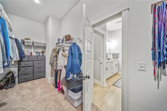 walk in closet featuring light wood-style flooring