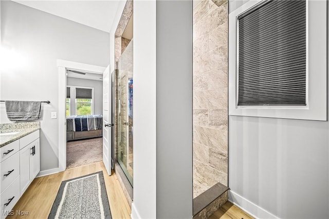 full bathroom featuring ensuite bath, a shower stall, vanity, and wood finished floors