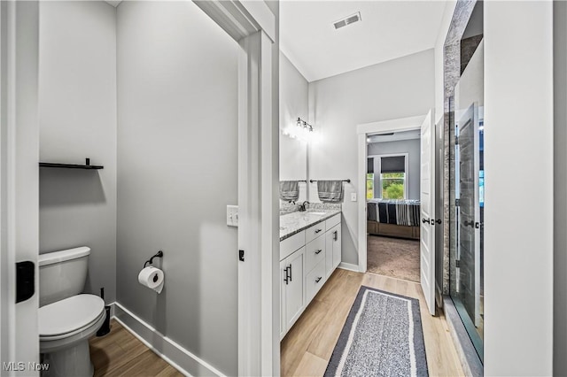 full bathroom featuring visible vents, toilet, wood finished floors, baseboards, and vanity