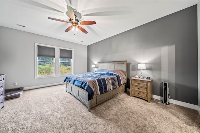 carpeted bedroom featuring visible vents, baseboards, and ceiling fan