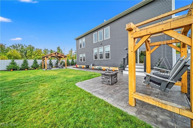 view of yard with a gazebo, a patio area, a fire pit, and fence