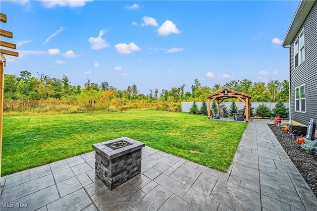 view of yard with a patio area, a fire pit, a gazebo, and a fenced backyard