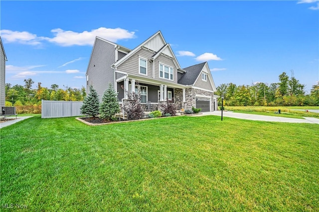 craftsman house with a porch, an attached garage, driveway, and a front lawn