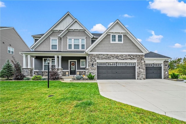 craftsman inspired home featuring a porch, a front lawn, and stone siding