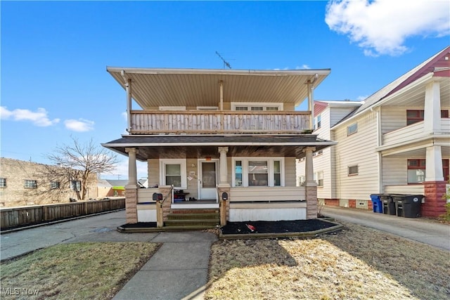 view of front of house with a balcony and covered porch