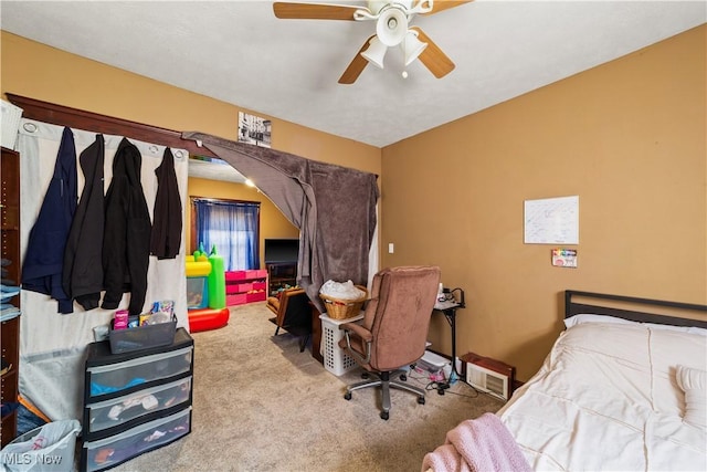 carpeted bedroom featuring visible vents and ceiling fan